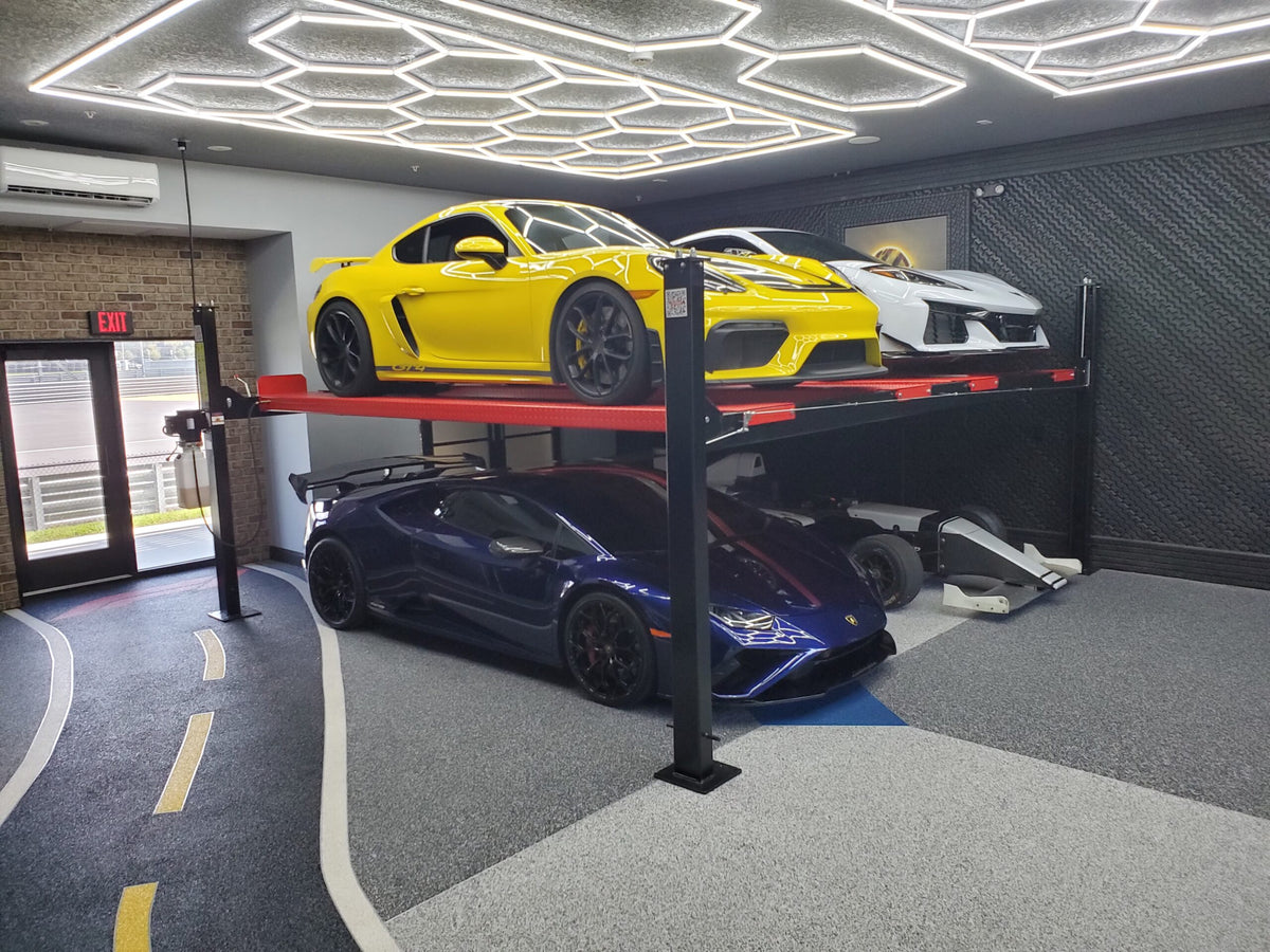 Real Olympic 4PXW-10 double-wide stacking lift installed in a custom garage